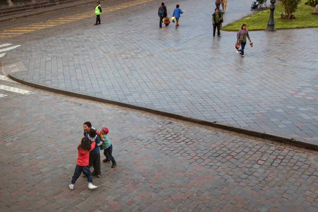 Kids play fighting in the plaza