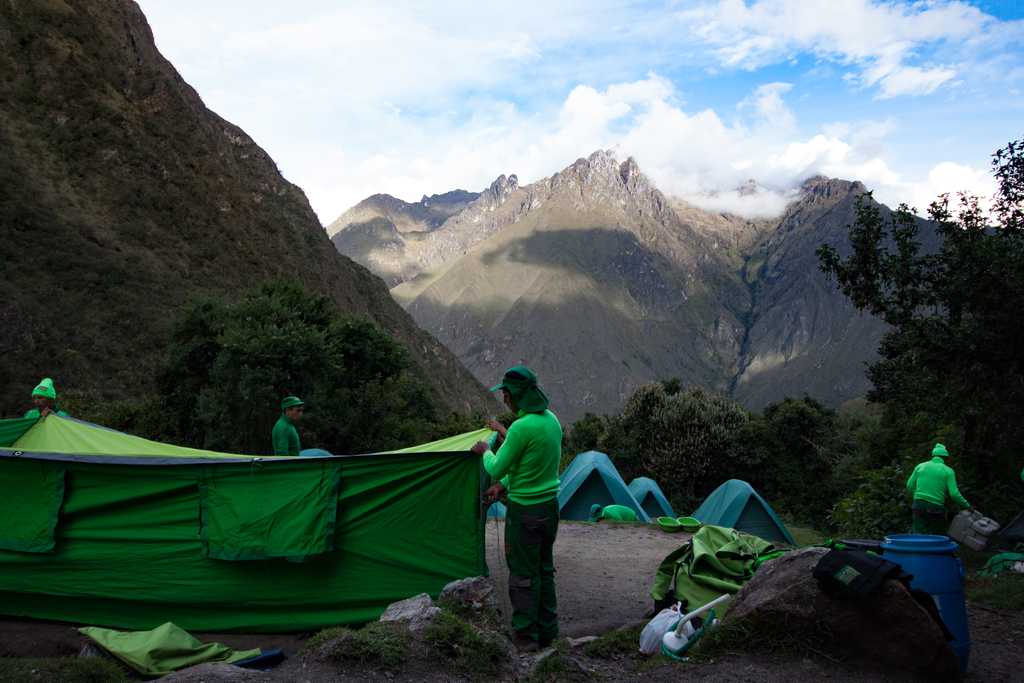 Porters packing down the tents